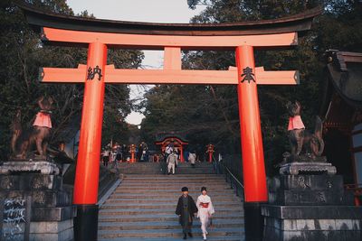 People at temple outside building
