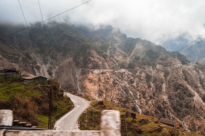 Panoramic shot of road by mountains against sky