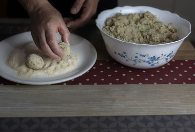 Close-up of person preparing food on table