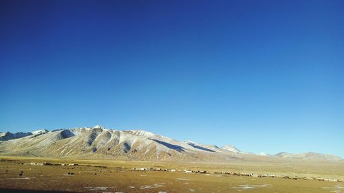 Scenic view of mountains against clear blue sky