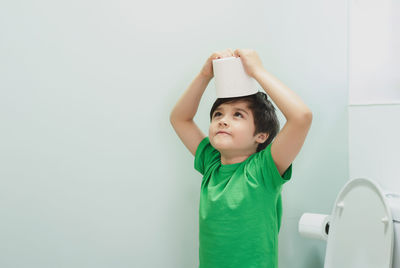 Boy standing against wall