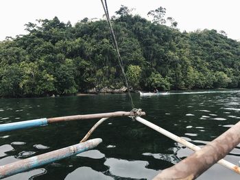 Boat sailing on river against sky