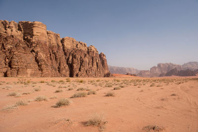 Sand dunes and sandstone cliffs in wadi rum desert , jordan