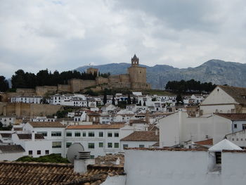 Buildings in town against sky