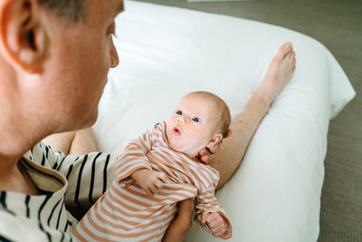 View from above of a newborn baby girl being held by her father