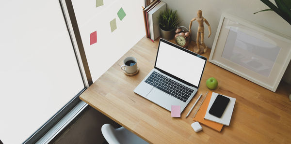 High angle view of laptop on desk in office