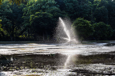 Water splashing in fountain against sky