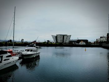 Boats in river with buildings in background