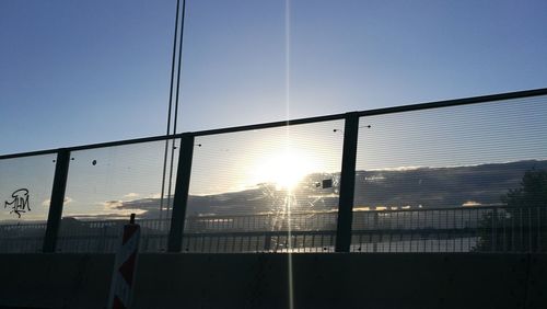 View of railing at sunset