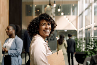 Side view portrait of happy female entrepreneur during seminar at convention center