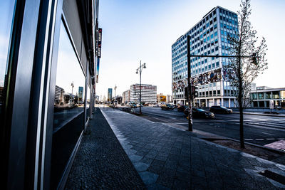 Street amidst buildings against sky in city