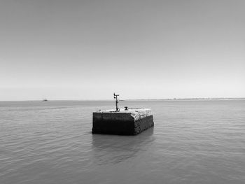 Boat on sea against clear sky