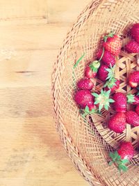 High angle view of strawberries in basket on table