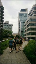 People walking on footpath in city