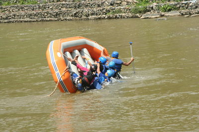 People in boat on river