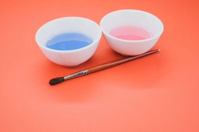 High angle view of tea on table against red background