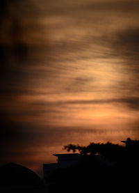 Silhouette trees against sky during sunset