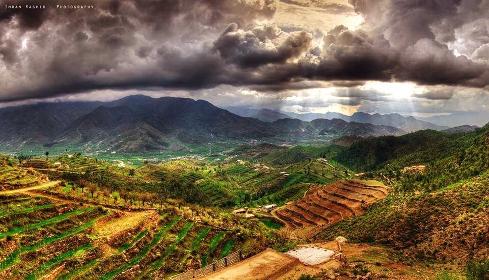 sky, cloud - sky, tranquil scene, tranquility, cloudy, scenics, landscape, beauty in nature, mountain, nature, cloud, weather, idyllic, mountain range, grass, non-urban scene, overcast, outdoors, field, remote