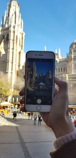 Man photographing at city street