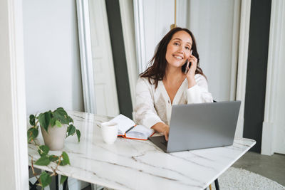 Young woman using laptop at home