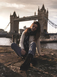 Portrait of senior woman with bridge in background