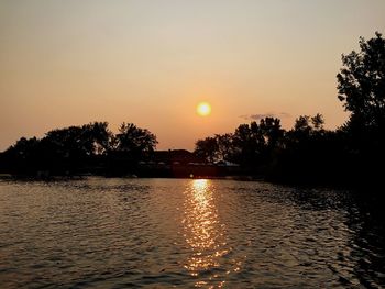 Scenic view of river at sunset