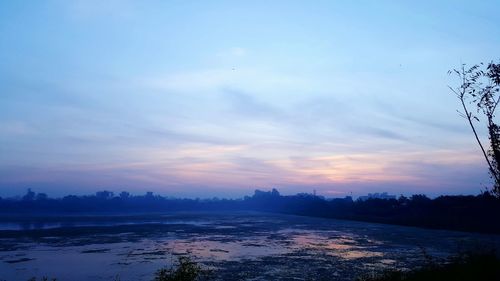 Scenic view of sea against sky at sunset