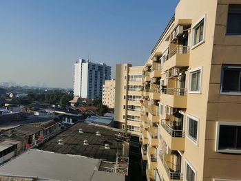 Buildings in city against clear sky
