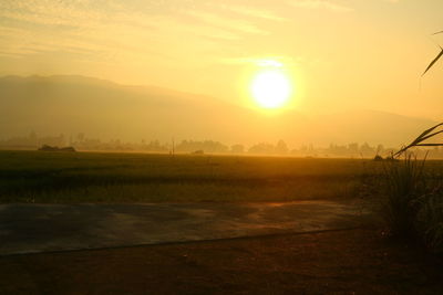 Scenic view of field against sky during sunset