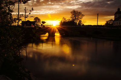 Scenic view of lake against orange sky