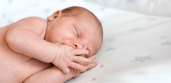 Portrait of beautiful baby on white knitted blanket. head and face. newborn baby. adorable child. 