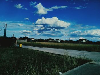 Scenic view of field against cloudy sky