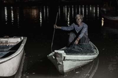 Portrait of man on boat in river