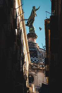 Low angle view of statue of historic building