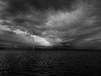 Scenic view of sea against storm clouds