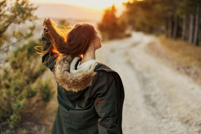 Rear view of woman standing on land