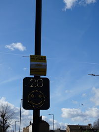 Low angle view of road sign against sky