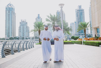 Business people discussing while walking in city