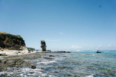 Scenic view of sea against clear blue sky