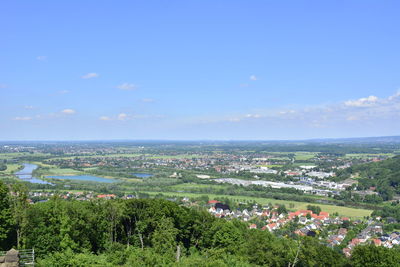 Aerial view of town by sea against sky