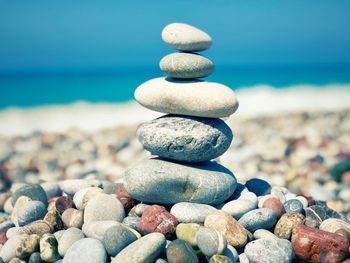 Close-up of stones stacked at beach