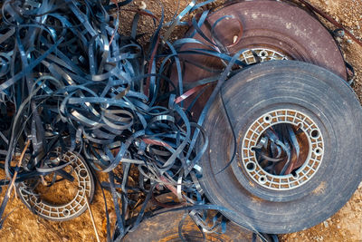 Directly above shot of damaged tires and rubber on field