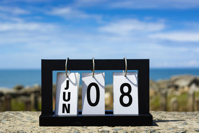 Jun 08 calendar date text on wooden frame with blurred background of ocean. calendar date concept.