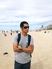 Portrait of young man standing on beach