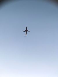Low angle view of airplane against clear sky