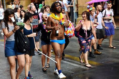 Group of people dancing on street in city