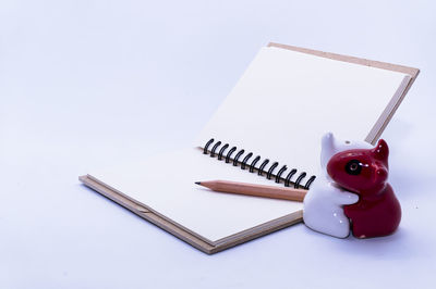 High angle view of telephone on table against white background