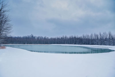 Scenic view of frozen lake against sky during winter