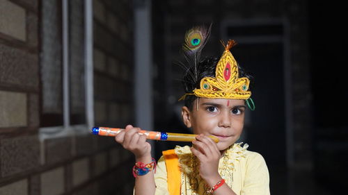 Asian boy posing as shri krishna or kanhaiya on fancy dress or gokulashtami festival.