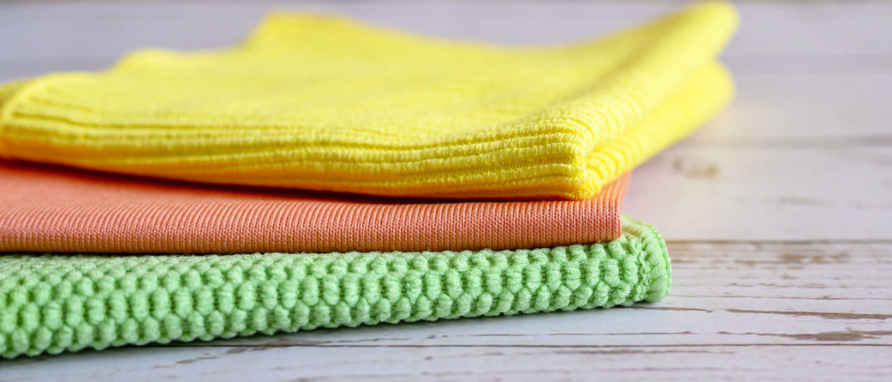 CLOSE-UP OF YELLOW HAT ON TABLE AGAINST WALL